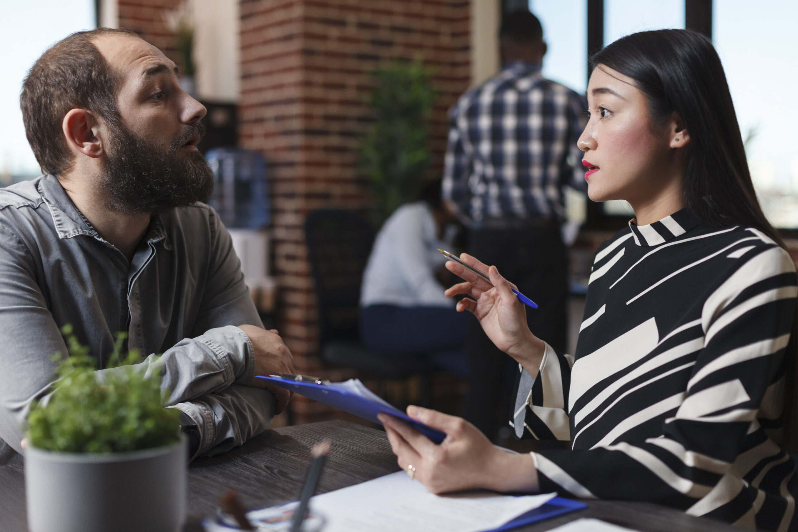 A professional discussing marketing matters with a client face-to-face.